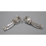 A pair of Art Deco style white metal, triangular and graduated baguette cut diamond set