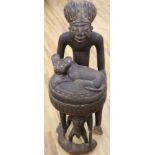 A large Bamileke carved wood figural storage vessel, Cameroon, length 109cm