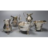 Five silver cream jugs, various dates and makers, including two bellied examples, one with scrolling