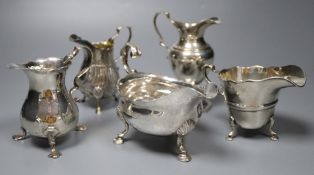 Five silver cream jugs, various dates and makers, including two bellied examples, one with scrolling