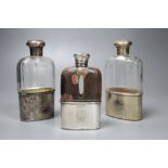 Two Victorian silver mounted glass hip flasks and a George V silver mounted glass hip flask, tallest