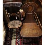 A Regency mahogany correction chair, a George III mahogany hall chair and two Victorian hall chairs