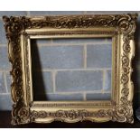 A Victorian carved giltwood and gesso picture frame, width 101cm height 87cm, aperture width 68 x