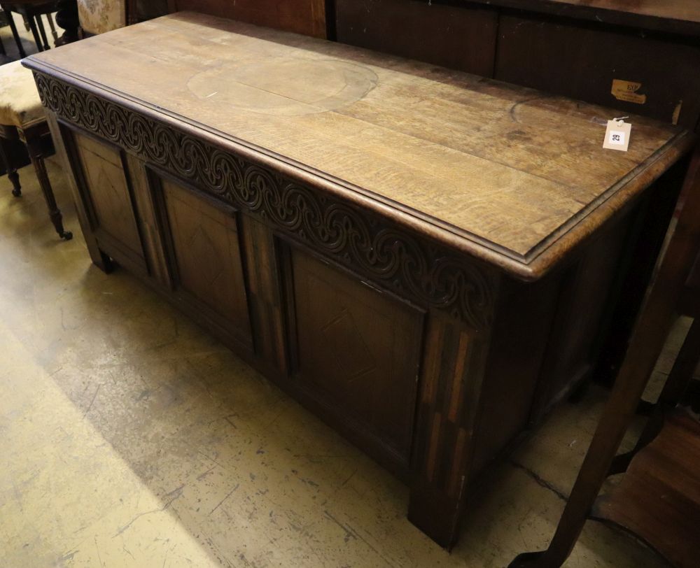 A 17th/18th century inlaid oak coffer with panelled front and planked top, width 145cm depth 53cm