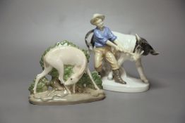 A Royal Copenhagen deer, model 2051 and a Sitzendorf figure group of a man and a cow.CONDITION: Good