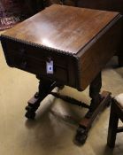 A William IV rosewood drop-flap sewing table, fitted two frieze drawers, carved with acanthus to end
