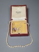 A single strand graduated cultured pearl necklace with yellow metal and gem set clasp (ex. ring