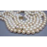 A single strand cultured pearl necklace and two simulated pearl necklaces.