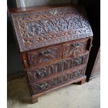 A small 18th century walnut bureau, later carved, width 76cm depth 47cm height 103cm