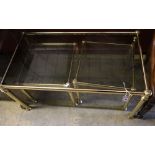 A nest of three brass and smoked glass tea tables, width 90cm depth 50cm height 44cm