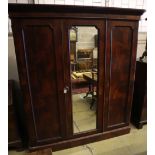 A Victorian mahogany three door wardrobe, with a central mirrored door, width 190cm depth 60cm