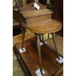 A Victorian mahogany sewing table on slender splayed baluster legs with brass caps and castors,