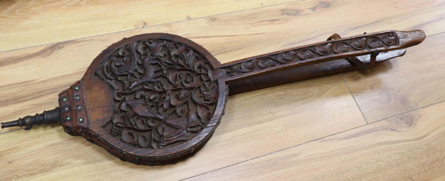 A pair of carved oak fire bellows