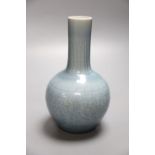A Chinese bottle vase with carved detail under a pale blue glaze, height 22cmCONDITION: A blue