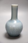 A Chinese bottle vase with carved detail under a pale blue glaze, height 22cmCONDITION: A blue