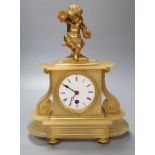 A late 19th century alabaster mantel clock, with gilt metal cherub surmount, French timepiece