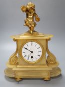 A late 19th century alabaster mantel clock, with gilt metal cherub surmount, French timepiece