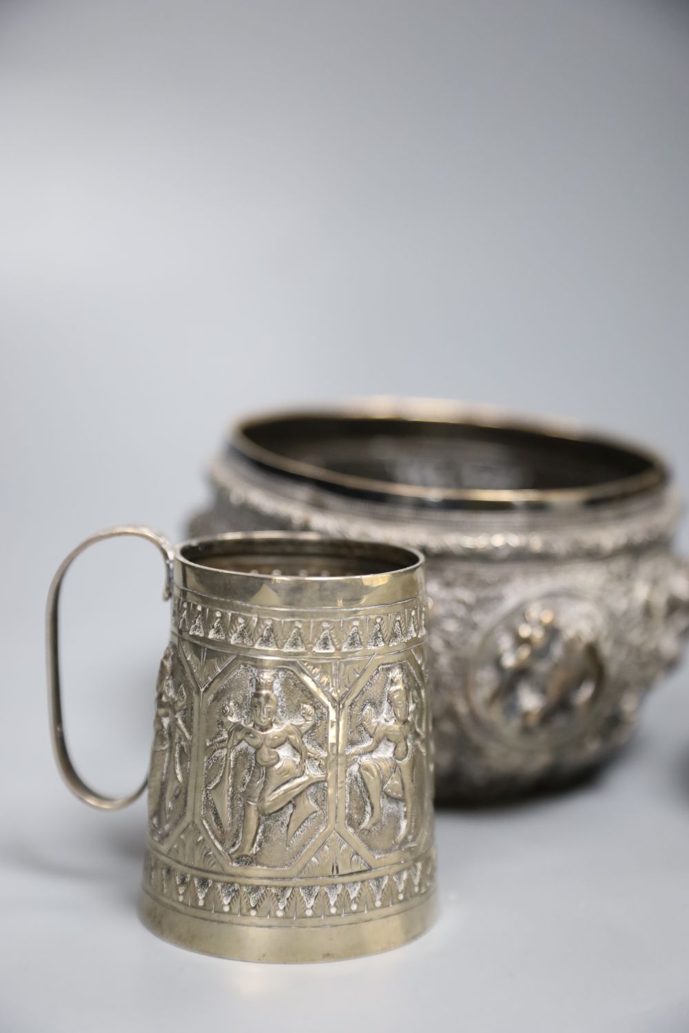 A 19th century Indian white metal embossed sugar bowl, a christening mug and a small brass bowl. ( - Image 2 of 4