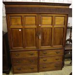 A large late Victorian walnut wardrobe, with fielded panelled doors over six small drawers, width