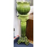 An apple green-glazed majolica jardiniere on matching stand with acanthus and other foliate