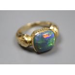 A yellow metal and opal set dress ring, size I, gross 7.4 grams.CONDITION: There are numerous