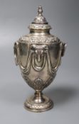 A George V silver vase and cover, with ram's head and swag decoration and two ring handles,