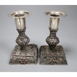A pair of continental filligree white metal and red stone set dwarf candlesticks (possibly Malta),