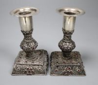 A pair of continental filligree white metal and red stone set dwarf candlesticks (possibly Malta),