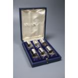 A cased set of six George V silver mounted cylindrical glass pepperettes, Harman & Co, London, 1928,