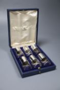 A cased set of six George V silver mounted cylindrical glass pepperettes, Harman & Co, London, 1928,