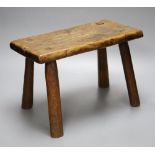 An elm milking stool, length 35.5cm