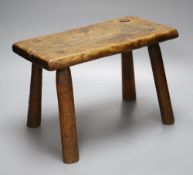 An elm milking stool, length 35.5cm