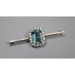 A white and yellow metal, emerald cut aquamarine and white topaz set bar brooch, 6cm, gross 7.2