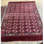 A Tekke Bokhara rug, red ground with lines of five guls, 280 x 200cm