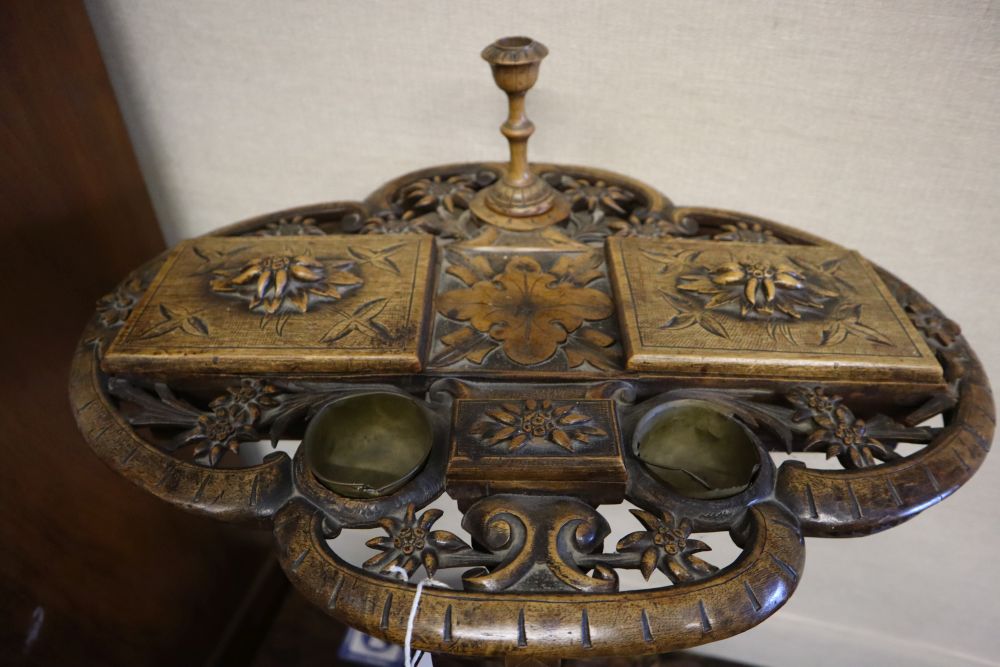 A 19th century Alpine carved fruitwood smoker's compendium, the quatrefoil top pierced and carved - Image 2 of 4