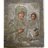 A 18th/19th century Russian painted wood icon with silvered brass oklad, Saint Theotohos
