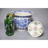 A Chinese blue and white jardiniere, a green glazed lion dog and a famille rose dishCONDITION: Green