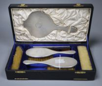 A cased George V six-piece engine-turned silver-mounted dressing table set, London, 1920/21&22.