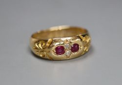 A late Victorian 18ct gold and gypsy set two stone diamond and two stone ruby ring, size K/L,