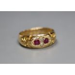 A late Victorian 18ct gold and gypsy set two stone diamond and two stone ruby ring, size K/L,