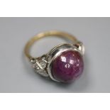 An 18ct and plat, cabochon purple star sapphire set ring, with diamond set shoulders, size N,