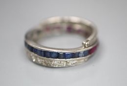 A white metal, diamond, ruby and sapphire swivelling eternity ring (ruby missing), size K, gross 5