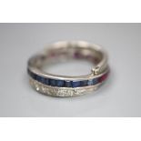 A white metal, diamond, ruby and sapphire swivelling eternity ring (ruby missing), size K, gross 5