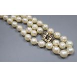 A single strand cultured pearl necklace, with yellow metal and thirteen stone diamond set clasp (