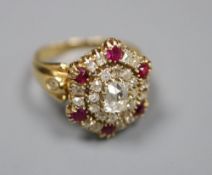 A Victorian style yellow metal ruby and diamond oval cluster ring, with central rectangular