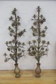 A pair of tall brass candelabra