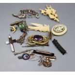 A small group of Victorian and later jewellery including a mourning brooch and silver and enamel dog