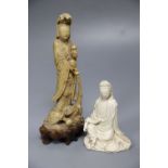 A 19th century Chinese carved soapstone model of Guanyin and a Kangxi Dehua figure of Guanyin (the