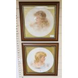 A pair of framed porcelain plaques of girls