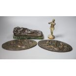 A bronze of a reclining female nude, a pair of plaques and a boy musician